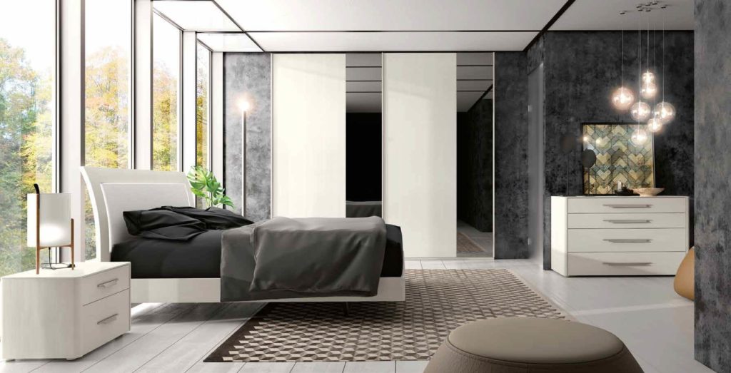 camera da letto moderna con letto , comò e comodino arredamenti divani torino